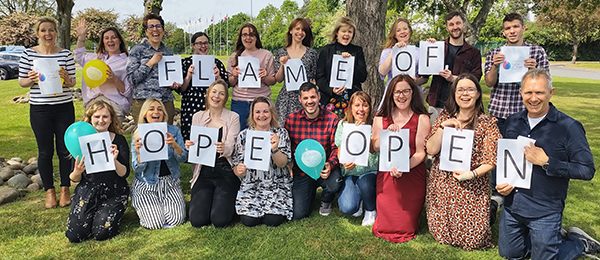 Flame of Hope banner held by the Volunteering Team