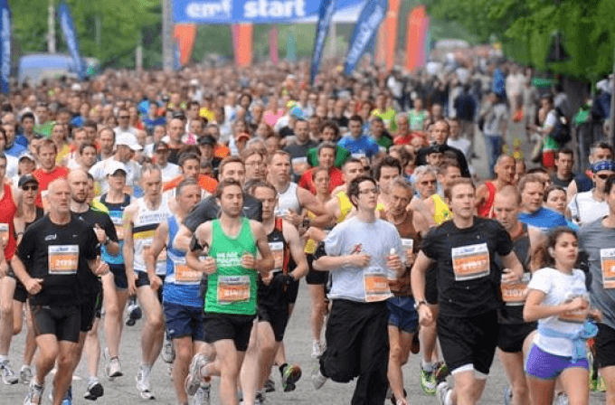 Take on the Edinburgh Marathon Group of runners in different coloured t-shirts running a marathon