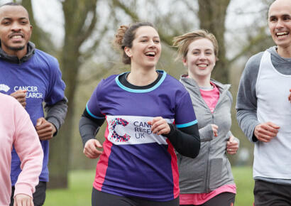 A woman running in a CRUK t-shirt