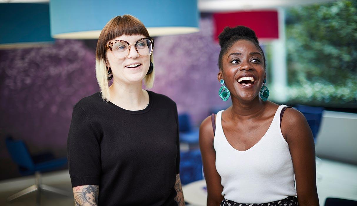 Photo of two female employees in the office smiling