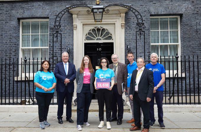 A group of people hand in a petition box outside number 10 Downing Street
