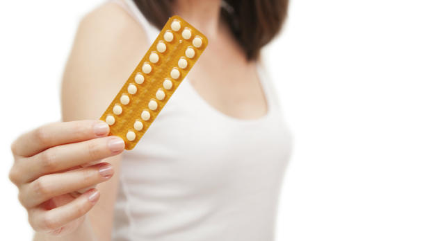 Woman holding birh control pills