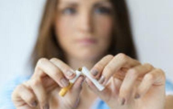 Woman breaks a cigarette in half