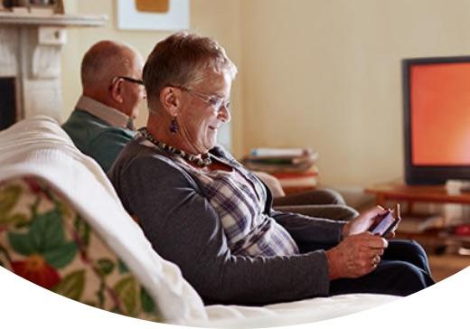 Person seated comfortably looking at tablet