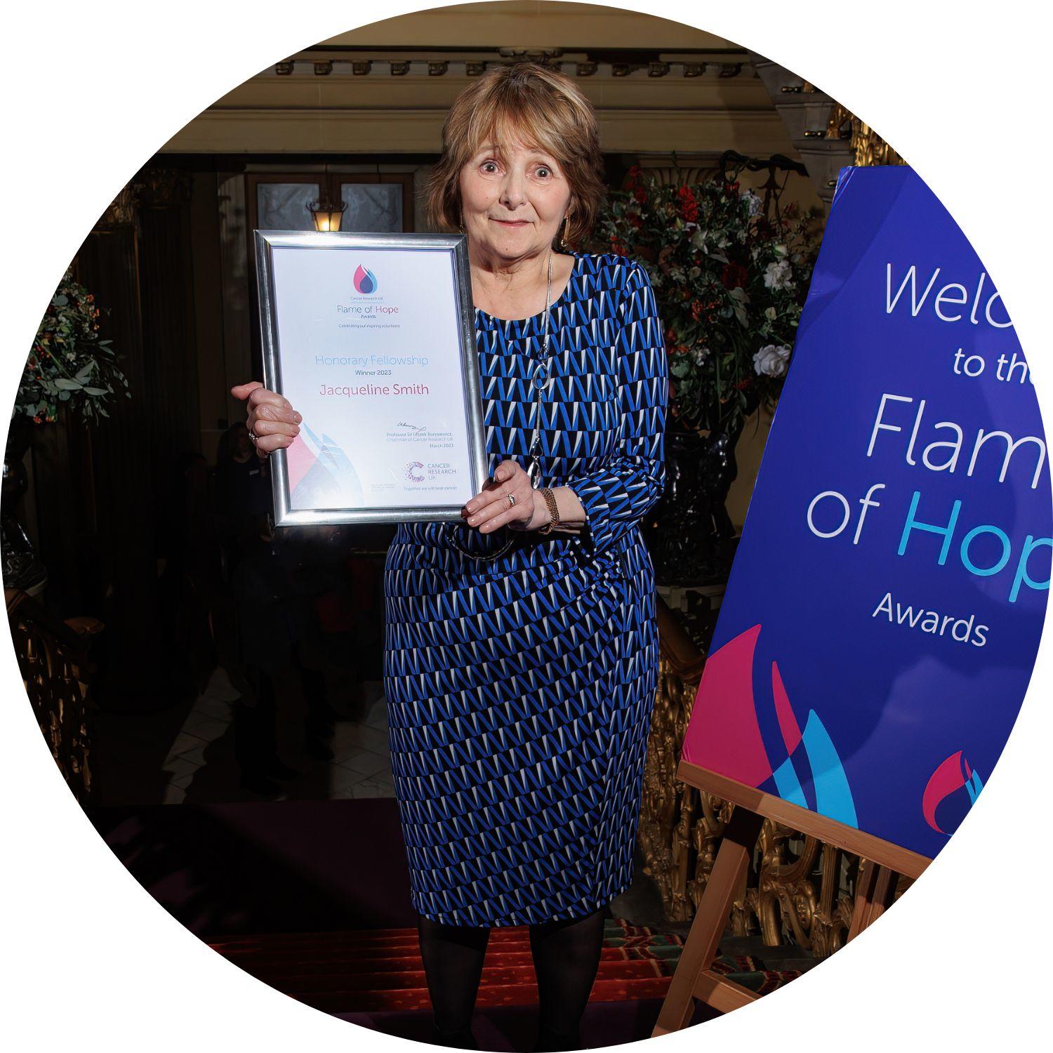 Jacqueline holding her Flame of Hope certificate