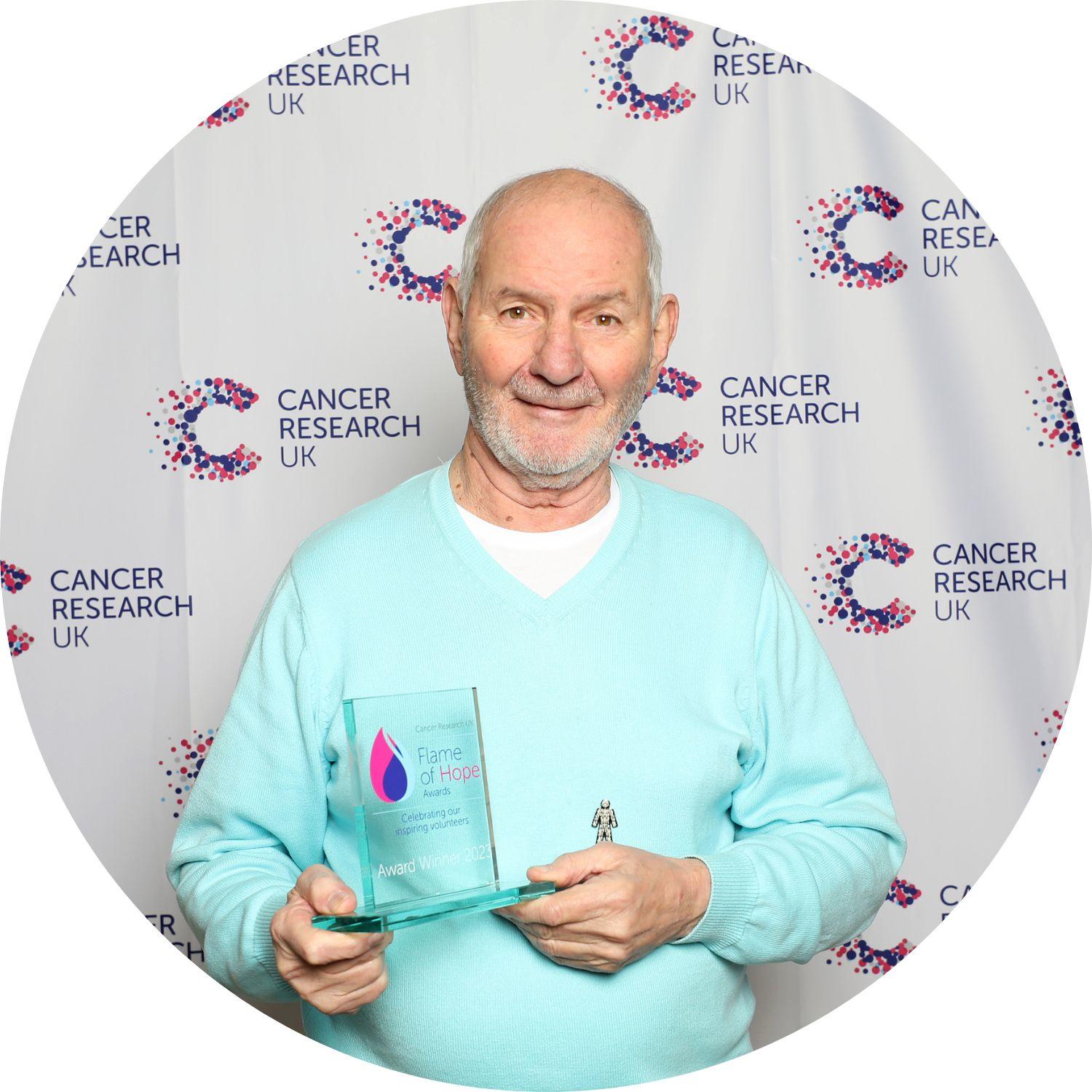 James holding his Flame of Hope trophy