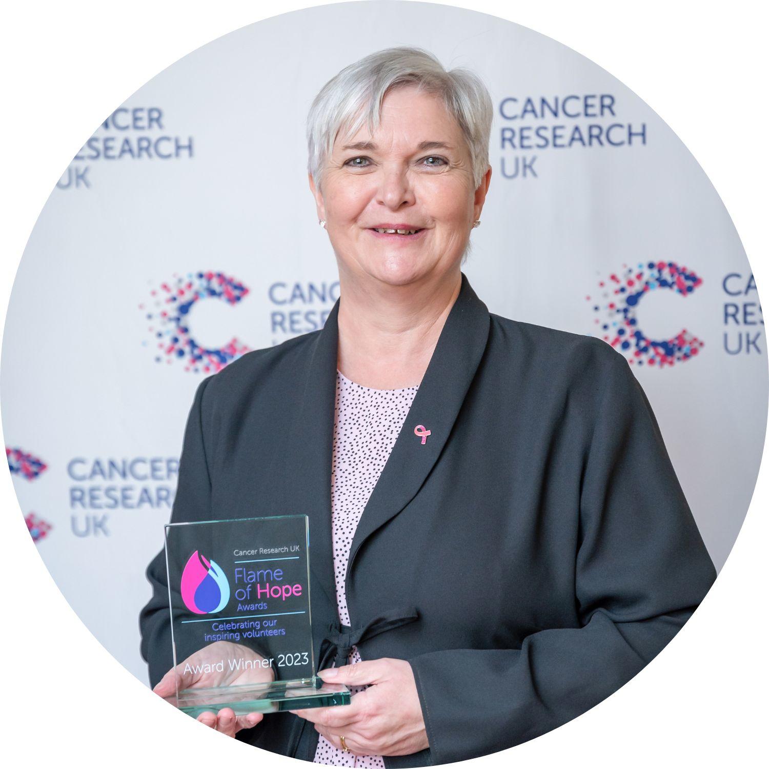 Jayne holding a Flame of Hope trophy