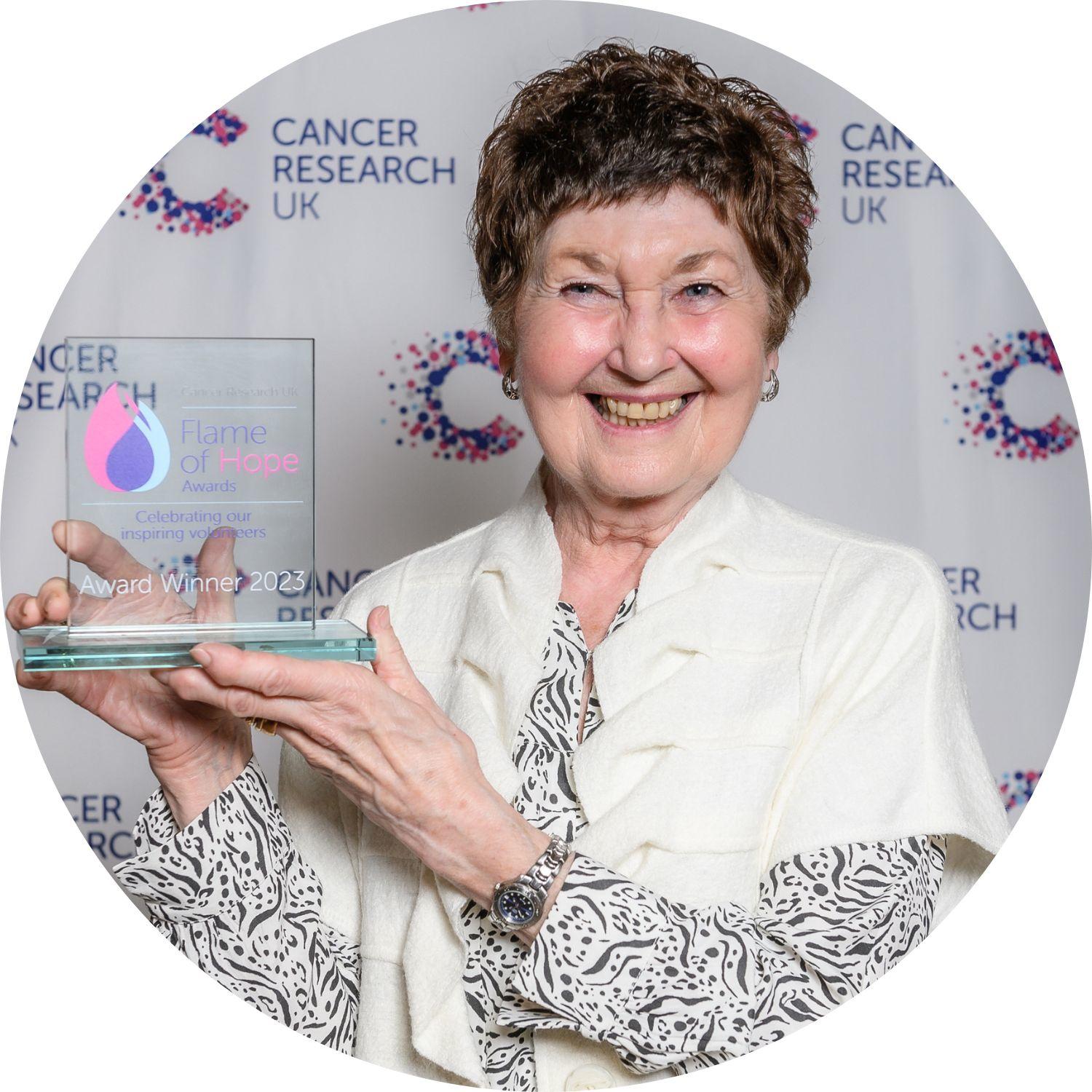 Joy holding her Flame of Hope trophy
