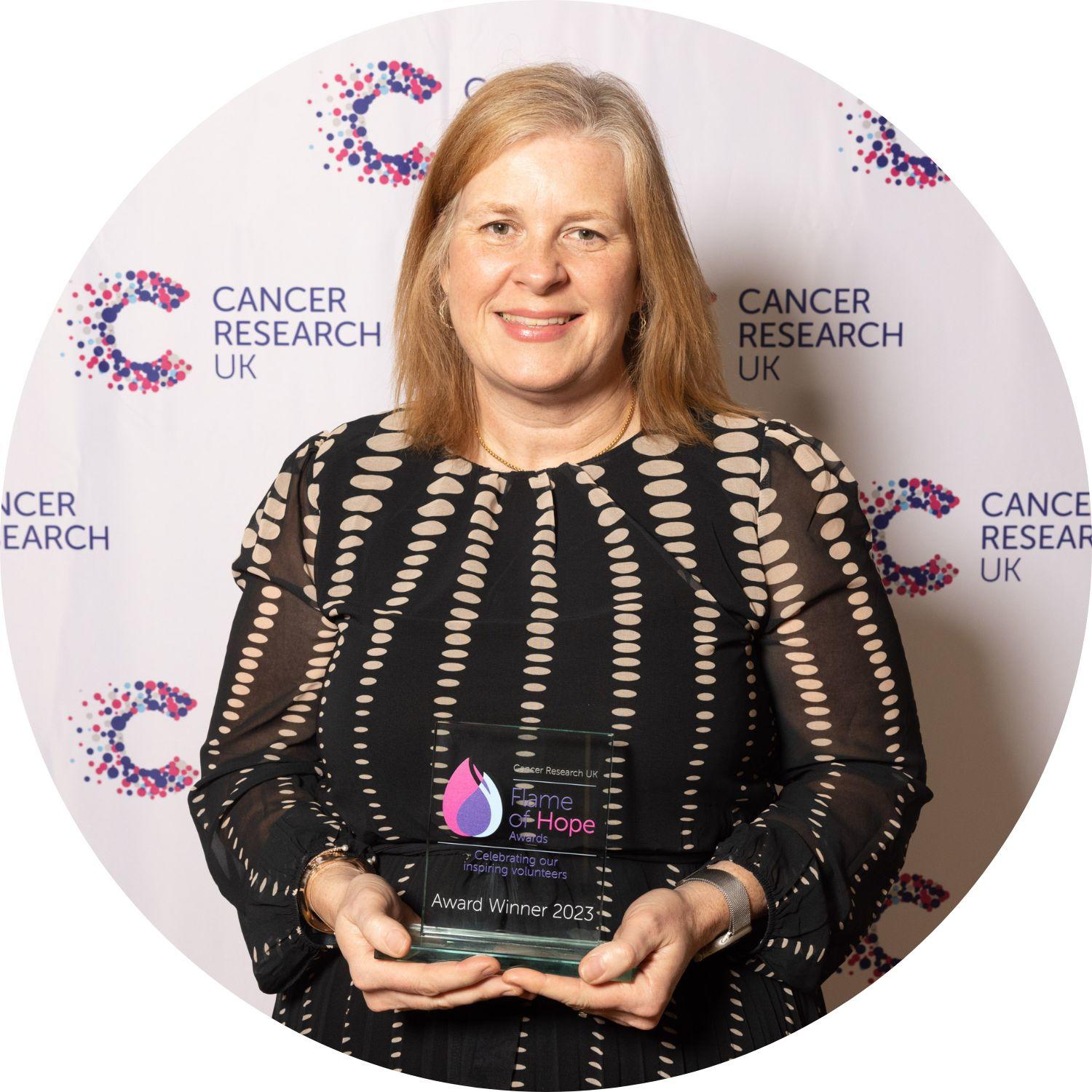 Julia holding a Flame of Hope trophy