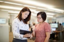 2 employees looking at laptop