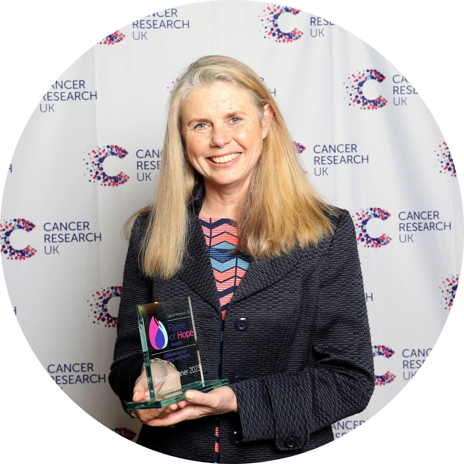 Karen holding her Flame of Hope trophy
