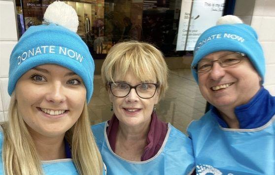 Megan and her parents smiling
