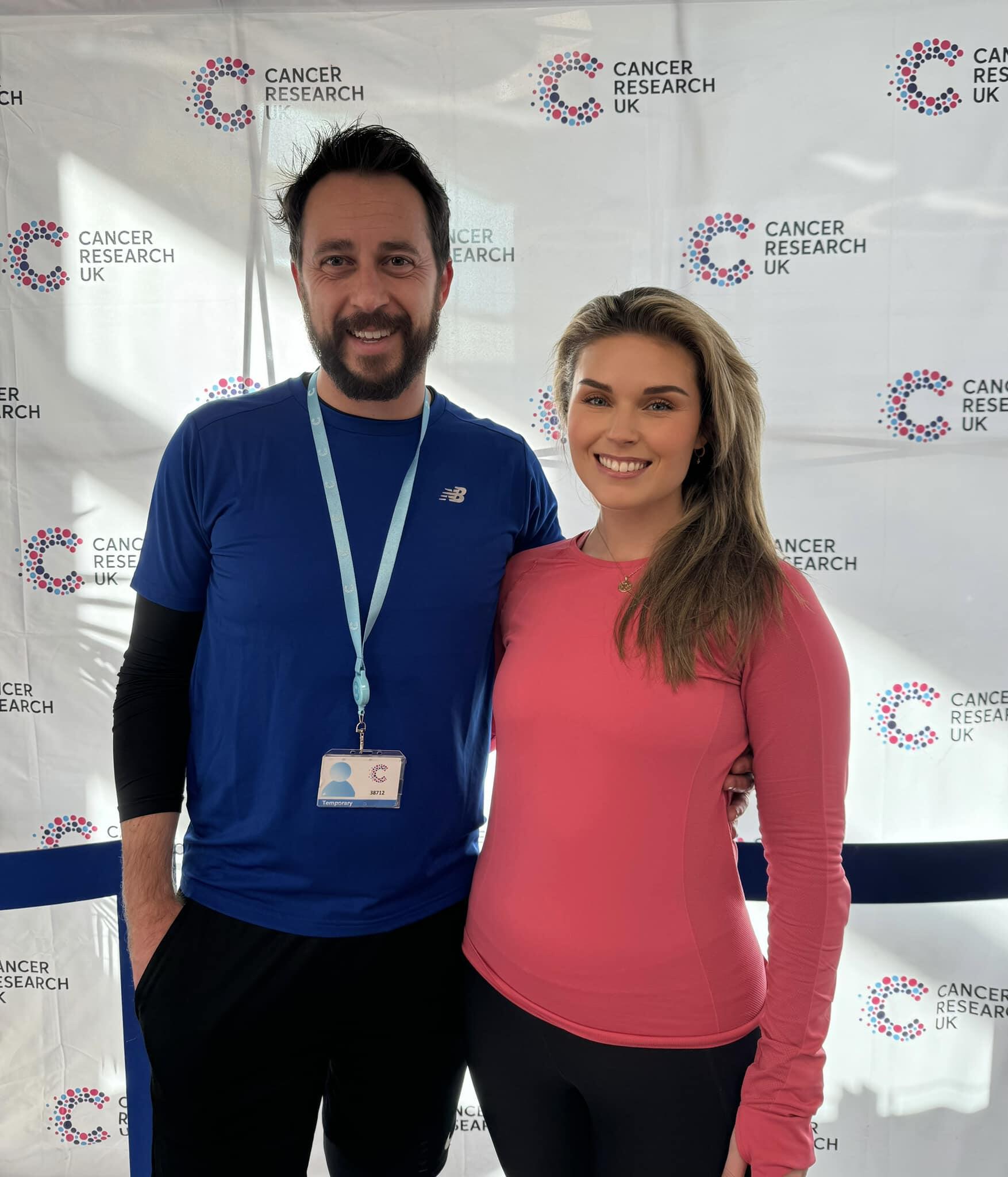 Image of two runners in front of CRUK background.