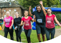 Five Race for Life participants smiling at the camera