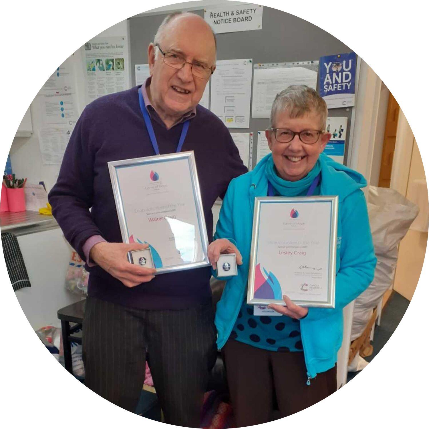 Walter and Lesley holding award certificates