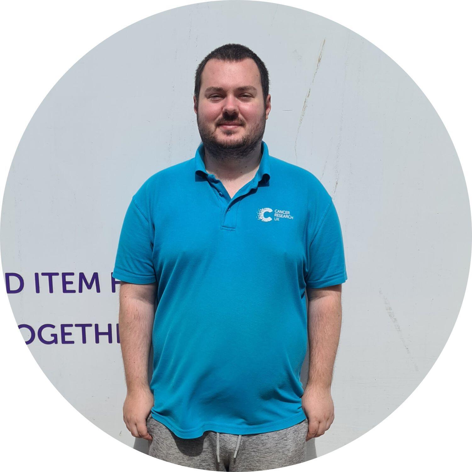 Liam standing in front of a CRUK van