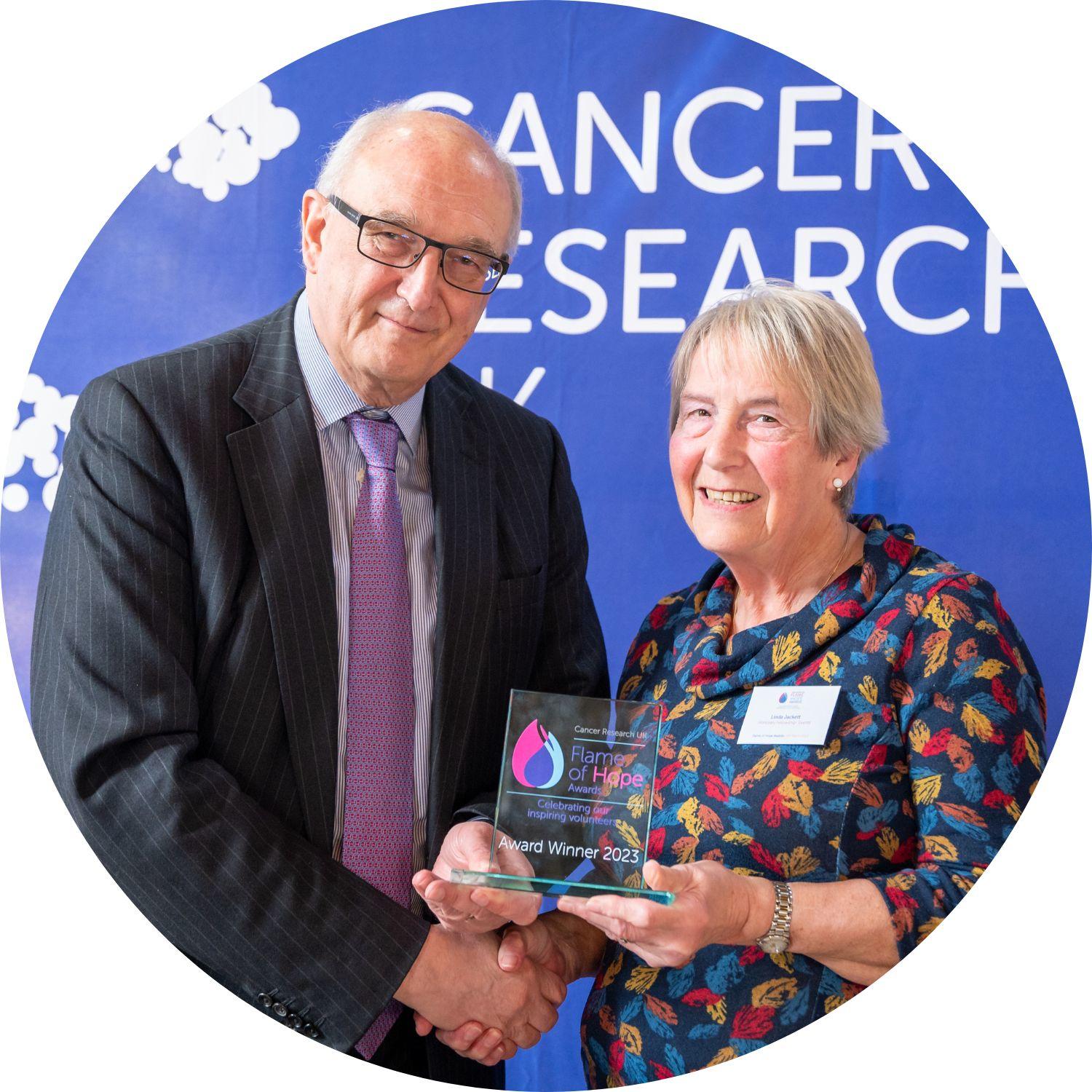 Borys and Linda holding a Flame of Hope trophy
