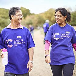 A man and woman walking in the park