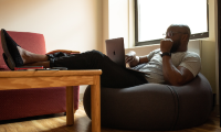 man on laptop relaxing