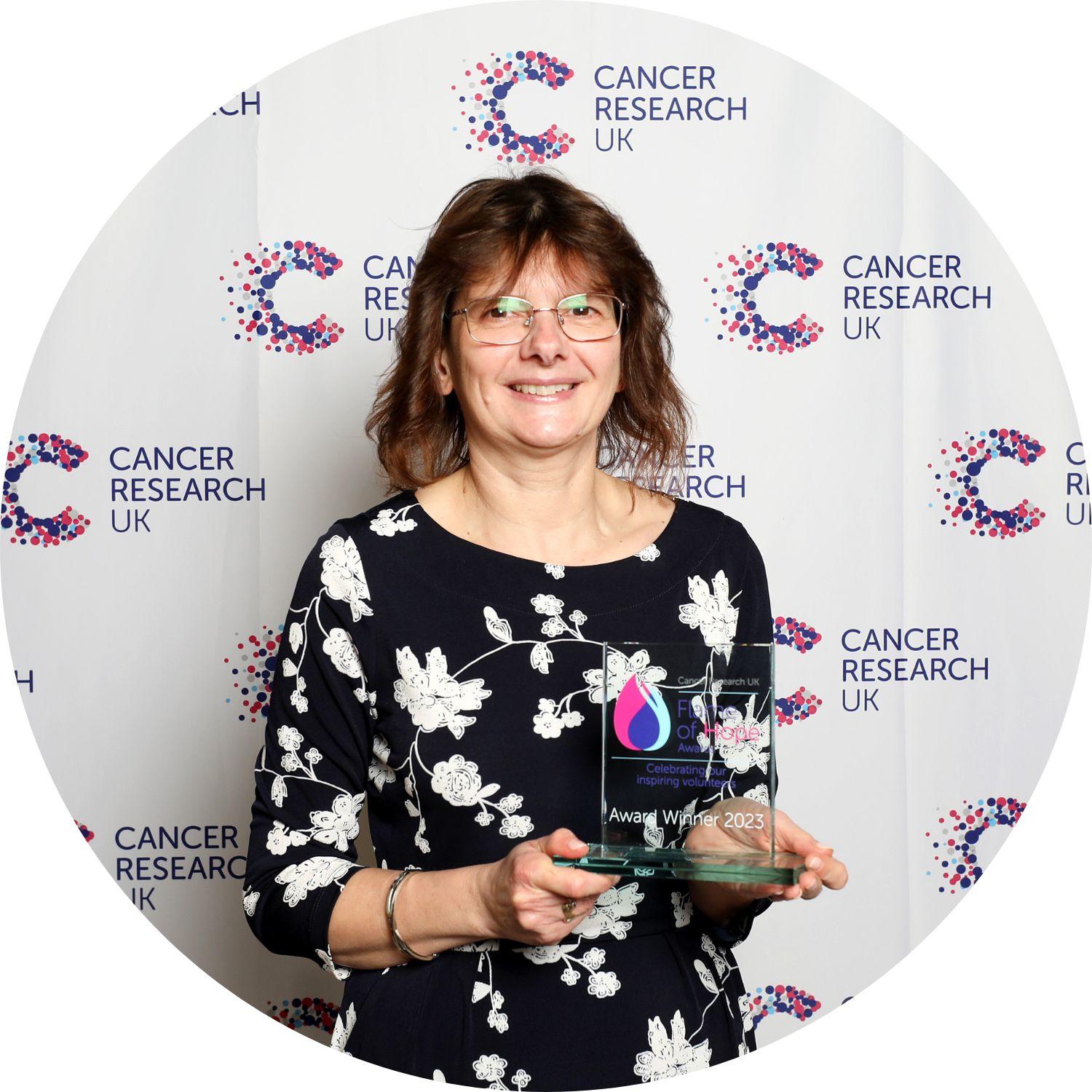 Mandy holding a Flame of Hope trophy