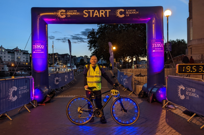 Mark with his bike in front of the start line at a Shine Night Walk