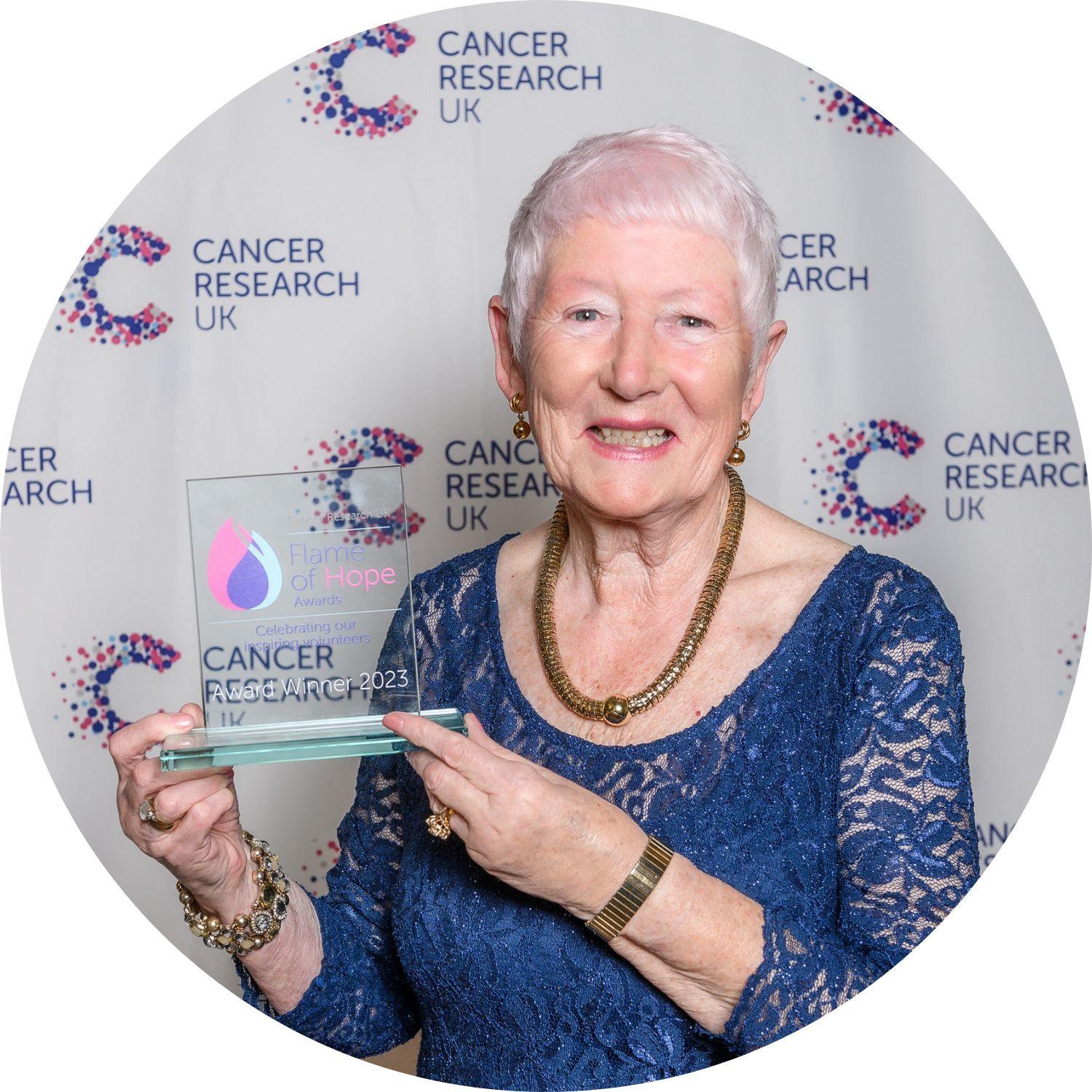 Mary holding her Flame of Hope trophy