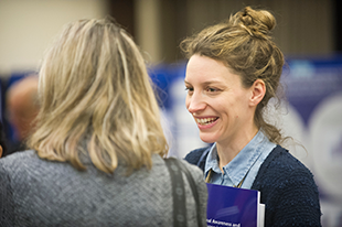 Two people talking at a conference