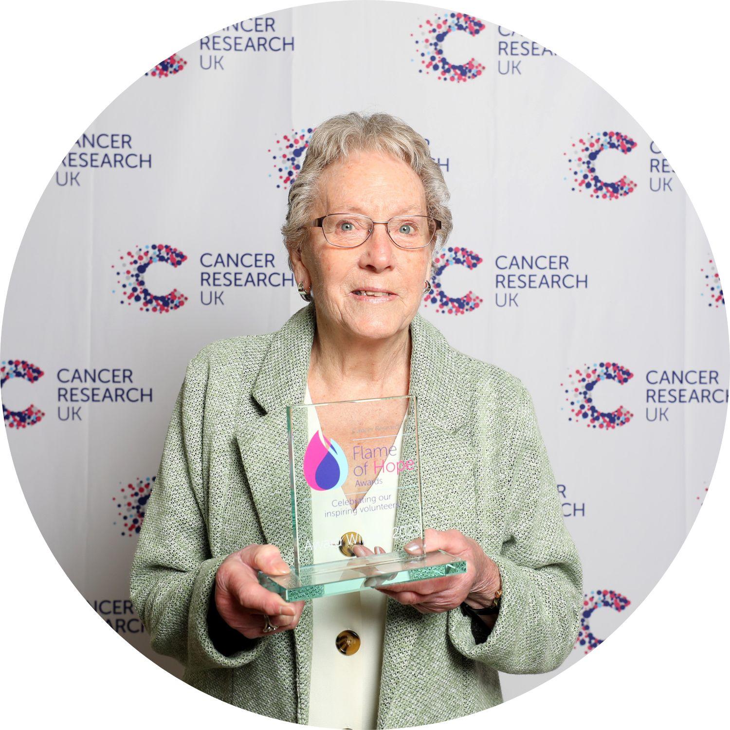 Nellie holding her Flame of Hope trophy
