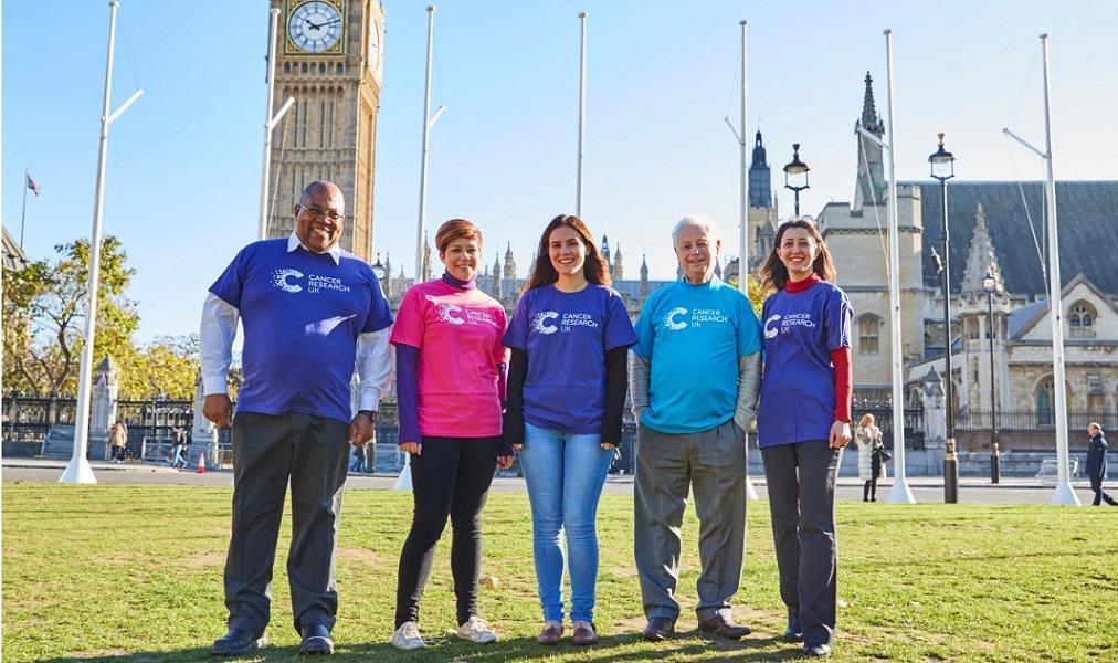 5 supporters posing next to Parliament