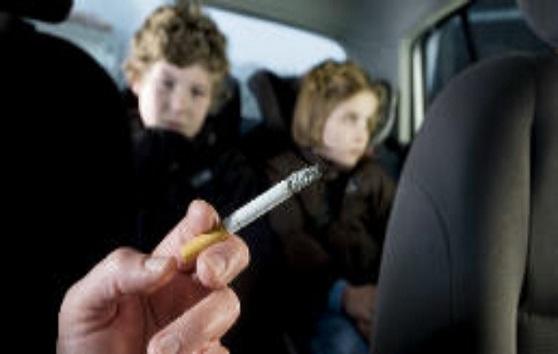 Children breathing in second-hand smoke in a car