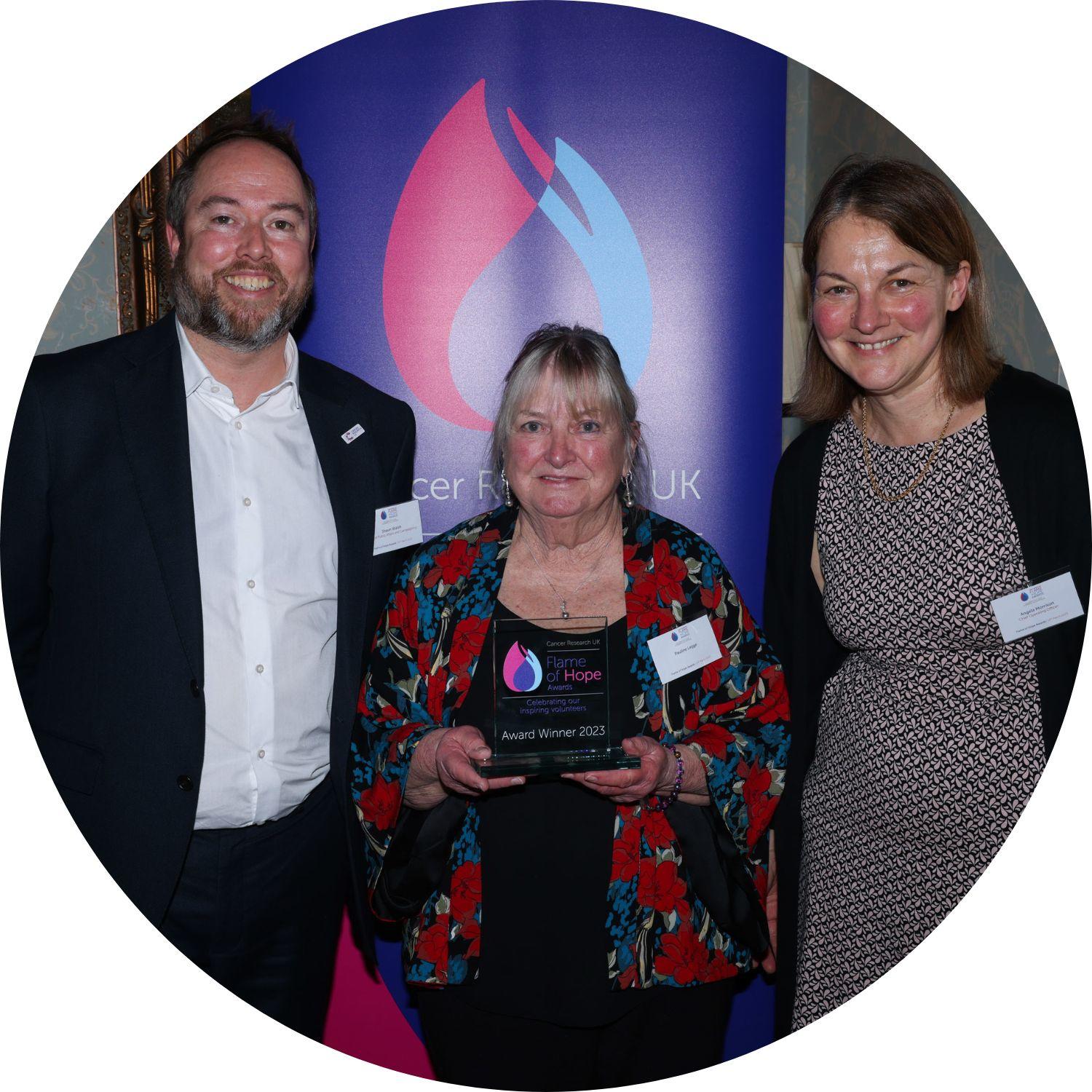 Pauline holding her Flame of Hope trophy, with Shaun Walsh to our left, and Angela Morrison to our right