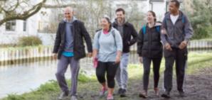 Happy family plays football in the park