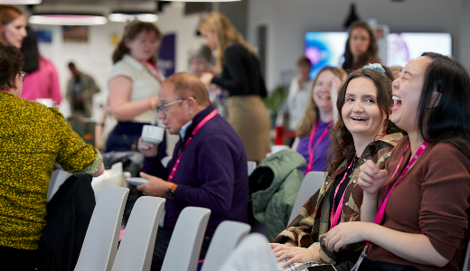 panel members in a meeting having a laugh