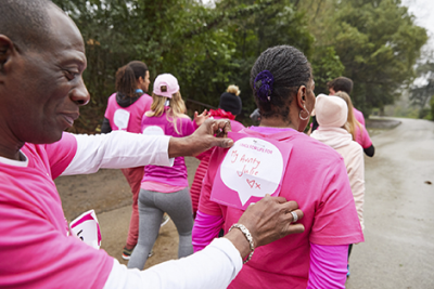 Volunteer attaching running number to participant