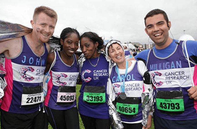 Runners in CRUK t-shirts smiling