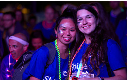 Two women smiling at the camera at Shine Night Walk