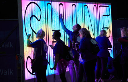 Participants writing messages on Shine event sign