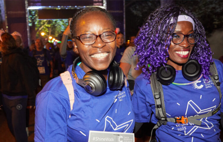 people smiling wearing Shine Night Walk T-shirts