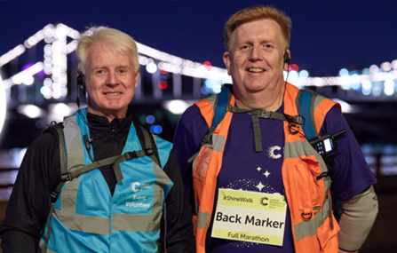 two volunteers smiling
