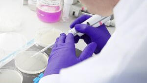 Scientist using pipette in lab