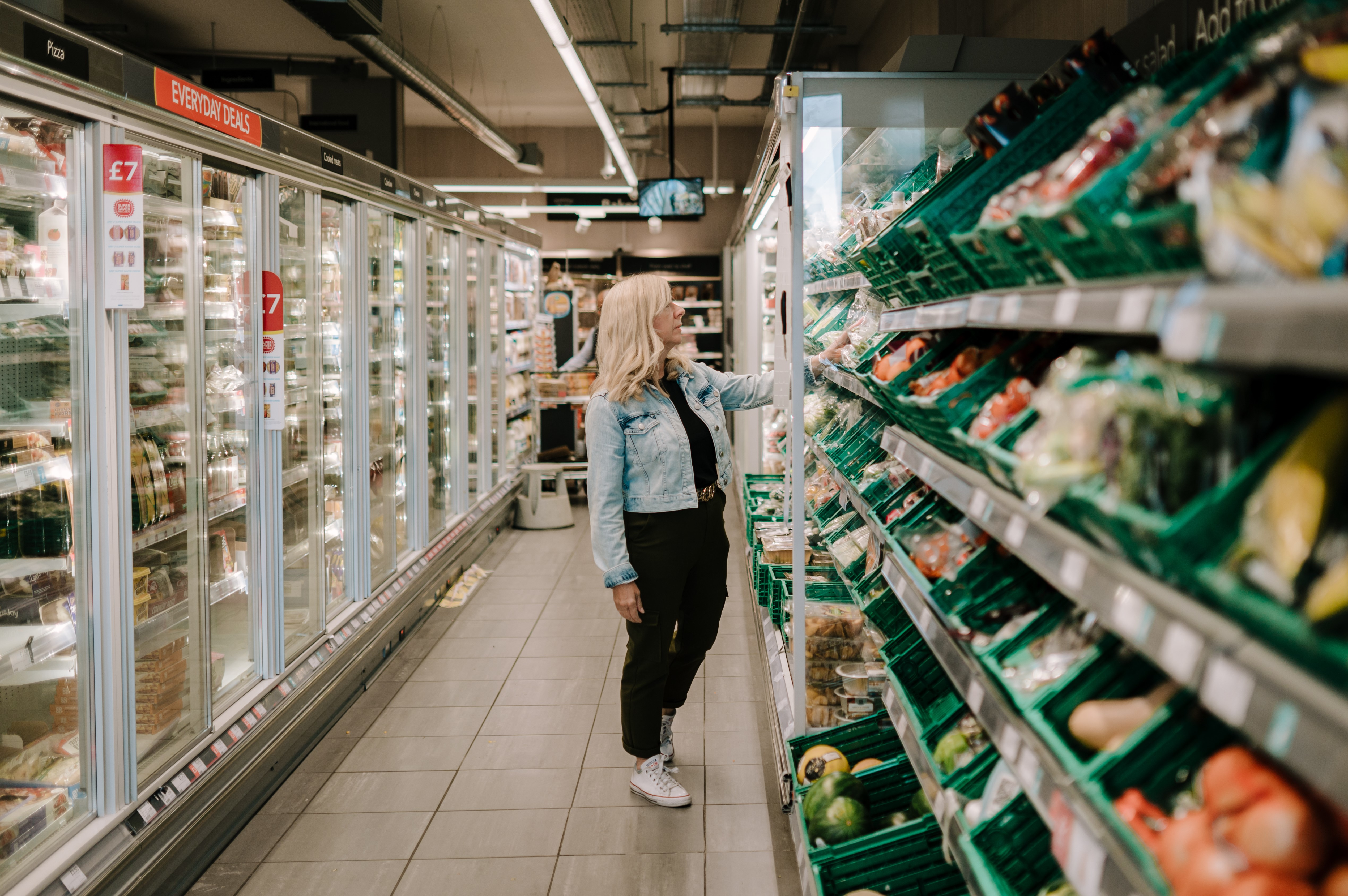 A woman in a shop looking at food options