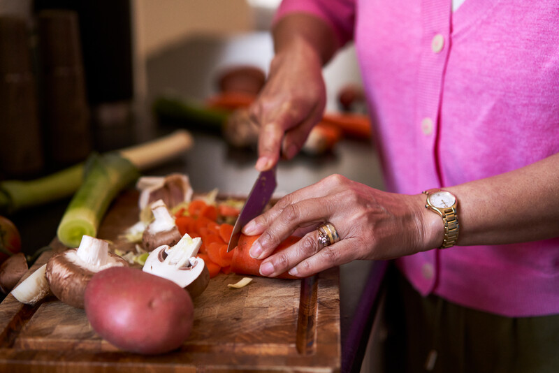 A person cutting vegetables on a chopping board