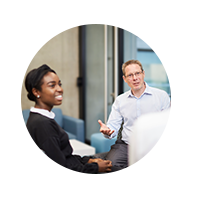 Three people having a conversation in an office