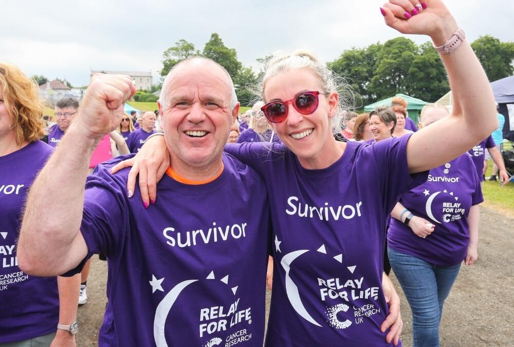 Sign up Survivor, two people celebrating at Relay For Life - photographer Brian Thompson