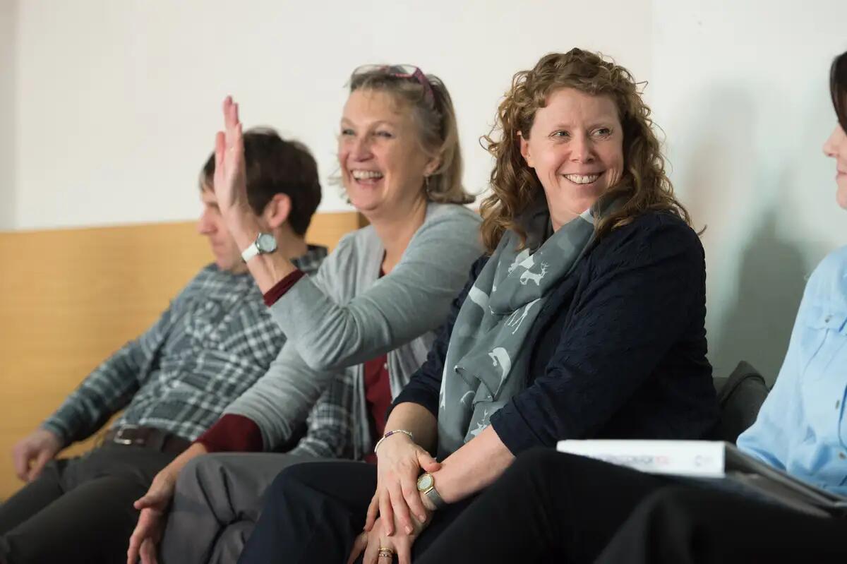 people smiling at a cancer training programme session