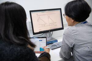 Two women looking at a screen 