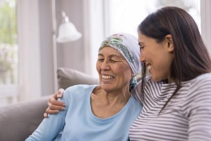 Smiling young woman embracing an older relative