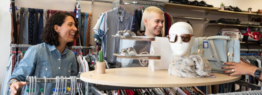 Two volunteers working in the shop
