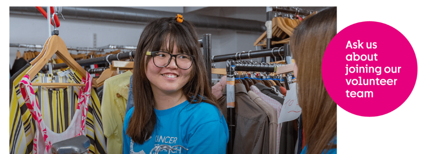 Volunteer smiling at a customer