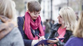 Woman signing petition in the street 